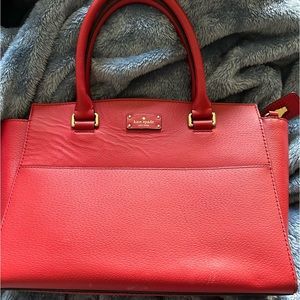 Kate Spade red satchel - there is a ripple in leather on front